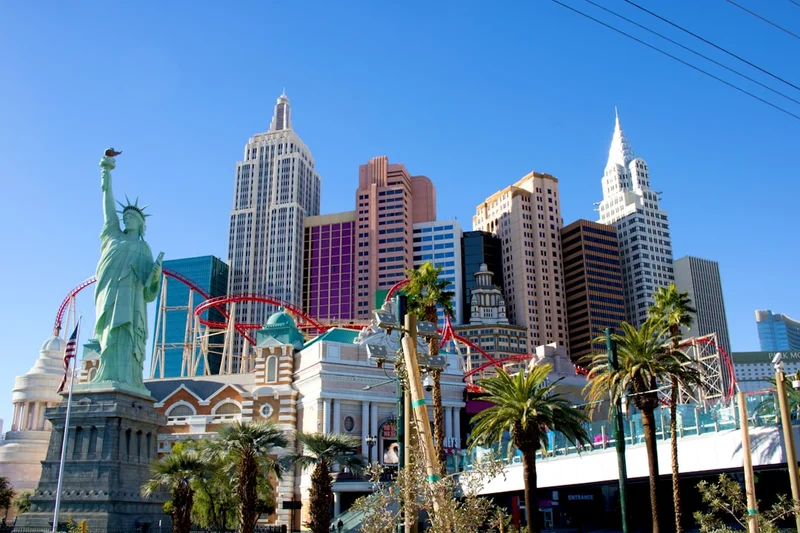 The statue of liberty stands in front of the las vegas skyline